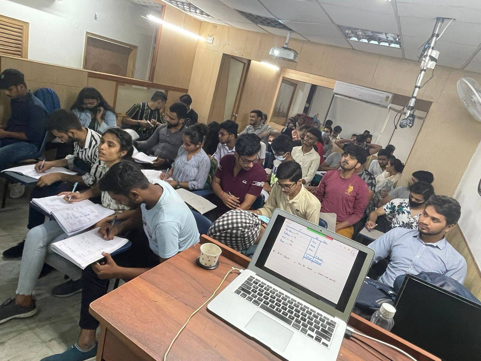 Students taking notes during a Commerce classroom session